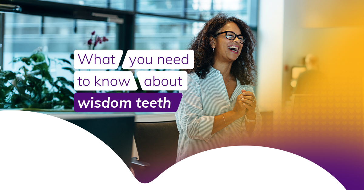 Smiling woman with curly hair and glasses standing indoors, clapping her hands mid-conversation. Overlaid text reads: 'What you need to know about wisdom teeth' in a mix of white and purple text boxes.