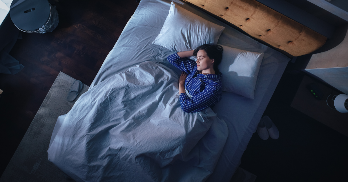 A woman sound asleep in bed.