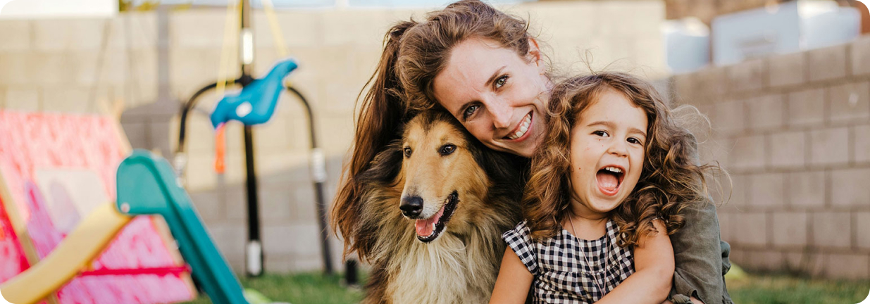 Woman, child and dog smiling