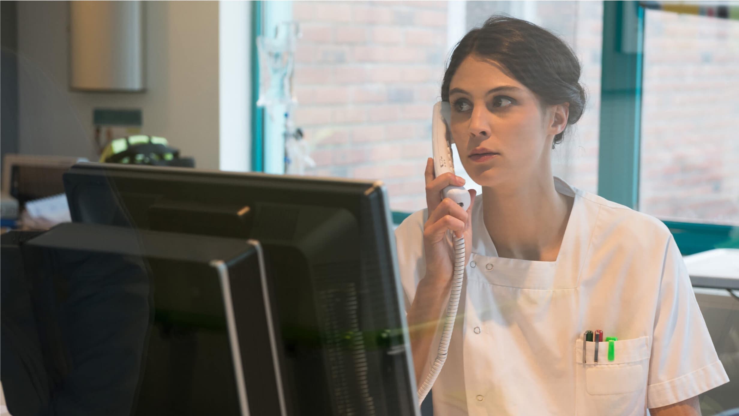 Nurse talking on a phone at work